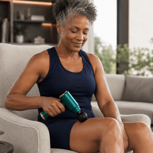 black woman using a massage gun