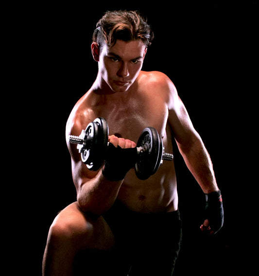 man with black dumbbell close-up photography