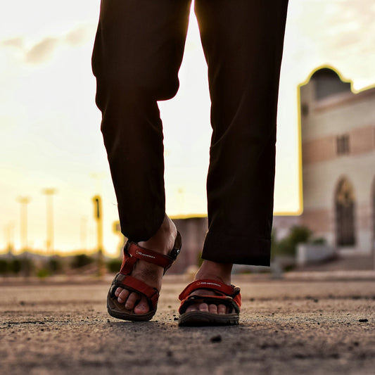 time lapse photography of person walking with red water sandals on
