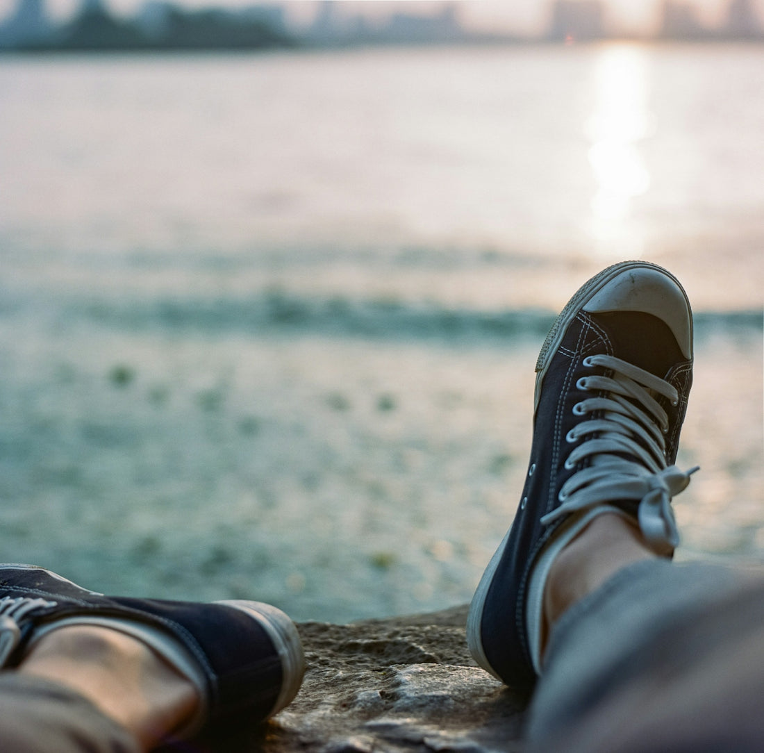 person wearing black and white sneakers