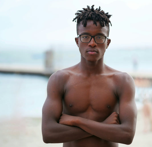 topless man wearing black framed eyeglasses
