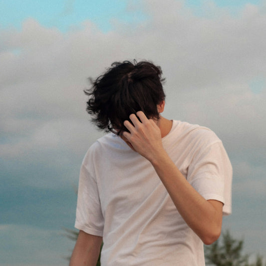 a man is covering his face with his hands