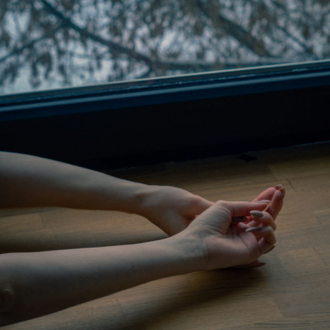 a person sitting on the floor with their legs crossed