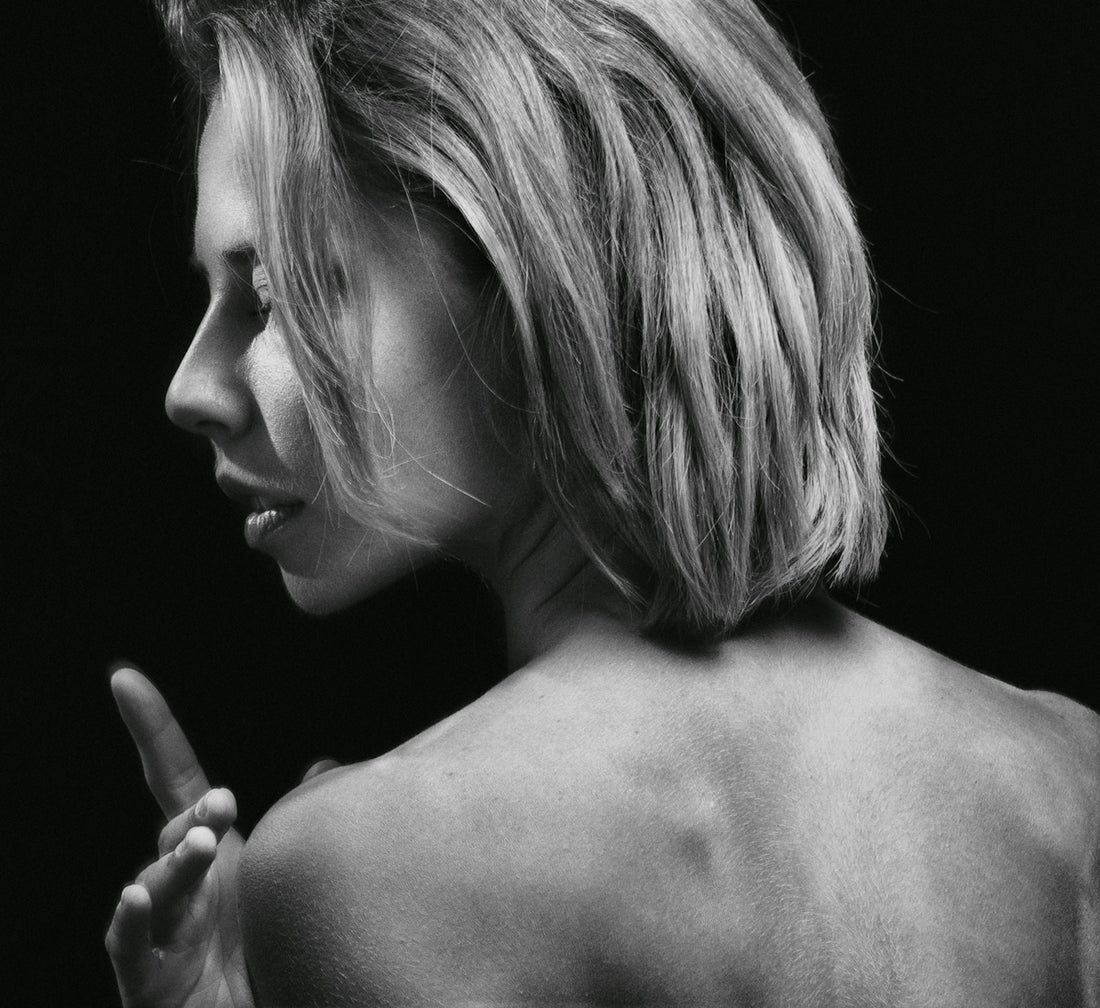 a black and white photo of a woman's back