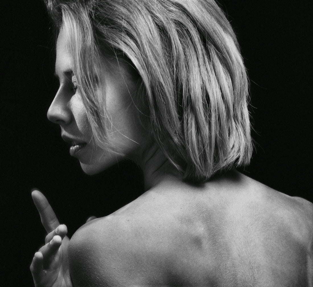 a black and white photo of a woman's back