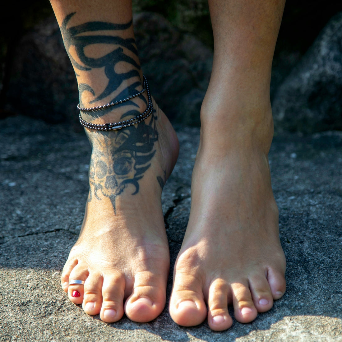 A close up of a person with a tattoo on their foot
